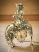 A Chinese brass vessel in the form of a man riding a horse,