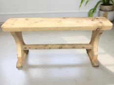 A rustic pine bench, width 105 cm.