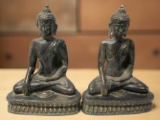 A pair of patinated metal figures of Buddha in lotus pose, height 20 cm.