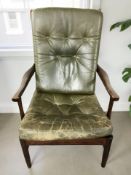 A Scandinavian stained beech ladder back armchair with solid green cushions,