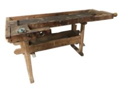An early 20th century pine work bench,