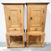 A pair of continental carved oak single door cabinets, each 53 cm x 29 cm x 120 cm.