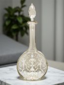 A 19th century cut crystal decanter, hand-painted with cherubs and floral swags, height 37 cm.