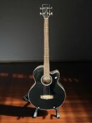 A Tanglewood electro-acoustic bass guitar, serial No. KH110514066, with a guitar stand.