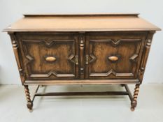 An early 20th century oak double door sideboard on barley twist legs, width 123 cm.