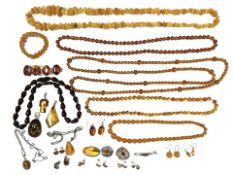 A good collection of amber, synthetic amber, and silver mounted jewellery including necklaces,