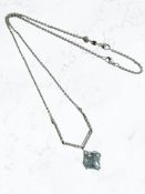 A blue topaz and diamond pendant, the square-cut topaz with a claw setting,