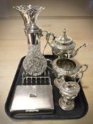 An ornate EPNS three piece tea service, together with a large flared rim bud vase, a decanter,