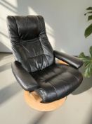 A Scandinavian laminated and black leather swivel armchair