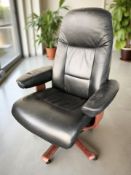 A Scandinavian bentwood and black leather swivel armchair and matching footstool