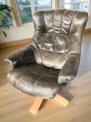 A Scandinavian bentwood and black leather swivel armchair