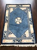 A Chinese woolen rug on blue ground, 197 cm x 126 cm.