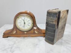 An inlaid walnut mantel timepiece, width 41 cm, and a volume 