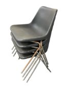 A set of four moulded plastic stacking chairs