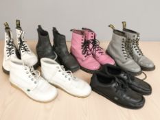 Three pairs of Dr Martens lace-up boots, and three further pairs of shoes.