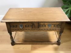 An Old Charm oak low table, fitted two drawers, width 92 cm.