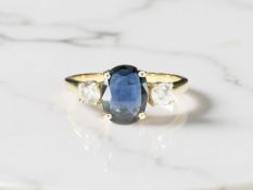 An 18ct gold sapphire and diamond ring, the oval-cut sapphire weighing an estimated 1.