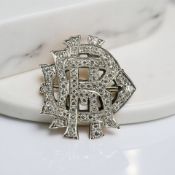 A gold and platinum monogram brooch, set with approximately 1.2 carats of diamonds, width 2.