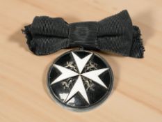 A silver and enamel Order of St. John medal.