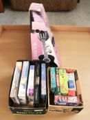 A group of board games, puzzles, child's classical guitar in box.