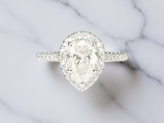 An 18ct white gold pear-cut diamond cluster ring, the principal diamond weighing an estimated 1.