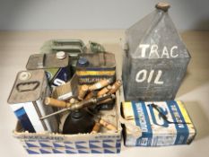 A group of vintage oil cans, jerry can, carpentry chisels.