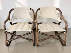 A pair of Scandinavian bentwood armchairs with slung fabric seats and back rests,