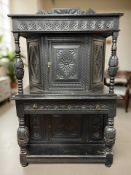 A 19th century carved and ebonised side cabinet, 102 cm x 55 cm x 162 cm.
