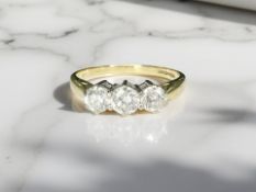 An 18ct gold three stone diamond ring, approximately 1.