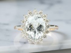 An 18ct white gold aquamarine and diamond cluster ring,