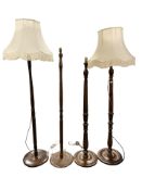 Four contemporary turned wooden standard lamps.
