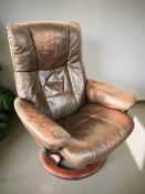 A Scandinavian bentwood and brown leather swivel armchair