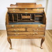 A reproduction eastern hardwood and brass inlaid cylinder writing bureau, 97 cm x 59 cm x 123 cm.