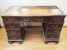 A Victorian-style mahogany pedestal desk with tooled leather top, width 122 cm.