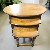 An Old Charm oak nest of three oval tables, width 82 cm.