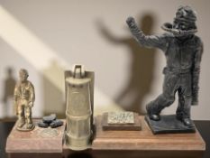 A resin figure of a miner on oak plinth,