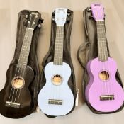 Three Mahalo ukuleles in soft carry bags.