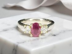 An 18ct gold ruby and diamond three-stone ring, size K. CONDITION REPORT: 5.