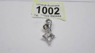 An ornate white gold and diamond pendant, 3.3 grams.
