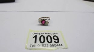 An opal and ruby gold ring, size M, 1.64 grams.