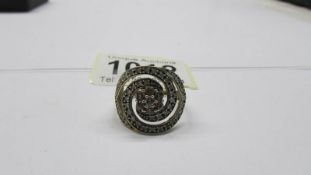 A large diamond swirl ring set in 9ct gold, size N, 3.37 grams.