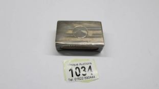 A silver match box holder.