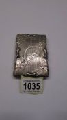 An ornate silver Walker and Hall card case with pencil, monogrammed M E C and dated 1915.