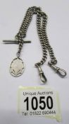 A hall marked silver watch chain with fob, 42.52 grams.