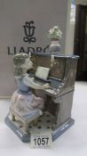 A boxed Lladro figure - Girl playing piano.