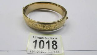 An engraved bangle marked 1/5 9ct M/C S & K.