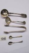 A sauce ladle, a sifter spoon, sugar tongs and two salt spoons.