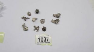Two silver boot charms and eight un-marked white metal charms.