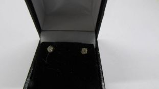 A pair of 30pt yellow gold and diamond studs.