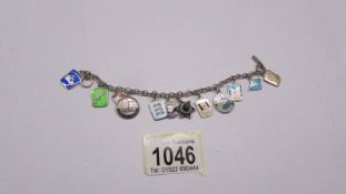 Twelve silver souvenir charms on a bracelet.